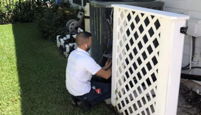 Hvac Technician Performing Maintenance On Condensor Hvac Technician Performing Maintenance On Condensor